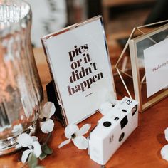 some dices are sitting on a table next to a sign that says pieces or it didn't happen