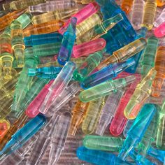 there are many different colored plastic toothbrushes on the table