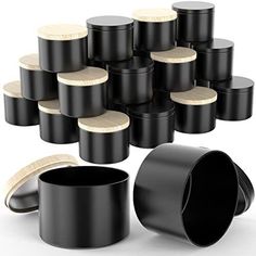 a bunch of black containers with wooden lids