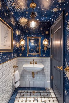 a bathroom decorated in blue and gold with stars on the ceiling