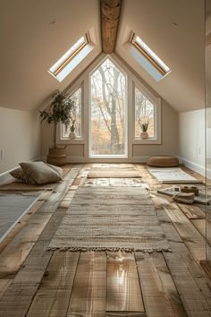 a room with wooden floors and skylights in the ceiling is filled with natural light