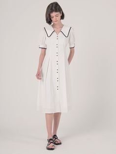 Editor's Notes Highlighted with the contrasting white on black outlines and buttons  this cotton dress has exaggerated collars that is balanced by a nipped-in waist.- Shirt-dress with two-button patterns down the front and on the sleeve-ends- Deep V-neckline with large collars that fall to the back as well- Puffed sleeves- Front and back nipped-in waist- Flared silhouetteMeasurements(in.)S / M- Length: 44.09 in. / 44.88 in. - Shoulder: 13.39 in. / 13.78 in. - Bust: 37.40 in. / 38. Elegant Daywear Dress With Striped Collar, Elegant Dresses With Striped Collar For Daywear, Classic Workwear Dress With Striped Collar, Classic White Cotton Midi Dress, Elegant White Dress With Striped Collar, Cotton Short Sleeve Dress With Striped Collar, White Collared Dress For Spring, Classic White Dress With Placket, White Cotton Dresses With Placket