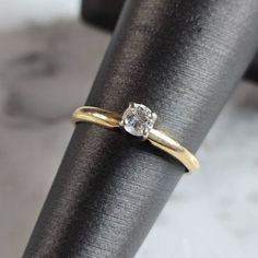 a gold ring with a diamond on it