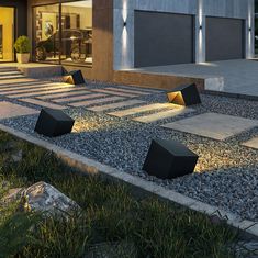 an outdoor area with stones, grass and lights