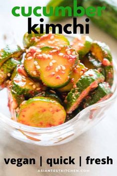 cucumber kimchi in a glass bowl with sesame seeds