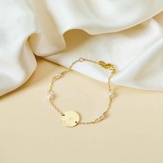 Perfect for all occasions, this personalized engraved Pearl Pastille Chain Bracelet features a delicate chain and freshwater pearls. Add a unique hand-engraved message on the front and reverse of the disc and create a sentimental keepsake, perfect for weddings, bridesmaid gifts or everyday wear.18K Champagne Gold Plated or 925 Sterling SilverBracelet measures 7, adjustable to 6.3Pastille Charm: 0.6 x 0.6Set with 4 freshwater pearlsEngraved by hand in our workshopSent with love from Paris in a co Personalized Pearl Bracelet, Personalized Pearl Jewelry, Elegant Name Bracelet With Engraving For Mother's Day, Elegant Hand Stamped Bracelets For Anniversary, Pearl Chain Metal Bracelet Gift, Elegant Engraved Bracelets For Bridesmaid Gift, Dainty Personalized Pearl Bracelet As A Gift, Personalized Pearl Jewelry For Gift, Elegant Personalized Pearl Bracelet For Wedding