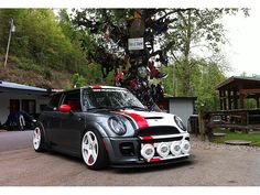 a small car parked in front of a tree