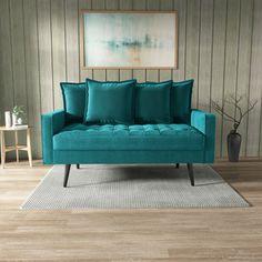 a blue couch sitting on top of a wooden floor