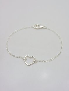 REAL STERLING SILVER - A QUALITY PIECEThis is an original design by The Violet Goat. I make this beautiful bracelet using a sterling silver heart charm set on sturdy sterling silver chain (all 925 sterling). Secures with a lobster clasp and comes in a gift box. These make great group gifts. Heart measures approximately 1/2 inch.FEATURED ON WOMAN'S DAY WEBSITE: This little beauty had the honor of being featured on several different sites, including a gift guide article for Woman's Day. This origi Mother's Day Sterling Silver Heart Bracelet Gift, Sterling Silver Double Heart Bracelet Gift, Sterling Silver Heart Charm Bracelet For Mother's Day, Minimalist Sterling Silver Heart Bracelet For Mother's Day, Minimalist Silver Heart Bracelet For Anniversary, Sterling Silver Double Heart Bracelets, Minimalist Silver Double Heart Bracelets, Adjustable Delicate Sterling Silver Heart Bracelet, Sterling Silver Open Heart Bracelet For Mother's Day