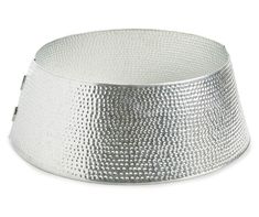 a silver metal bowl sitting on top of a white surface with holes in the middle