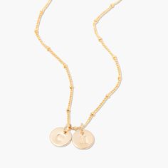 No matter where you are going, deck your neck with our classic Madeline two initial pendant. We love its delicate design and versatility. Rock it alone or as the base of an on-trend layered look. 3/8" 14k gold plated brass, rhodium plated brass or rose gold filled disc Hand stamped initial 16" brass satellite chain with 2" extender Lobster claw closure With customization this item is FINAL SALE NOTE - discs DO NOT slide on and off the chain. If you are looking to add or remove discs from the cha Everyday Rose Gold Initial Necklace With Adjustable Chain, Rose Gold Initial Necklace With Delicate Chain, Dainty Rose Gold Initial Necklace With Charms, Rose Gold Sterling Silver Initial Necklace With Delicate Chain, Dainty Adjustable Initial Necklace For Everyday, Delicate Rose Gold Initial Necklace For Everyday, Rose Gold Initial Pendant Charm Necklace With Delicate Chain, Dainty Rose Gold Initial Round Pendant Necklace, Everyday Rose Gold Initial Pendant Necklace