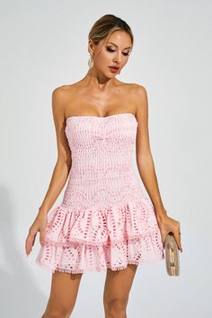 The Bridget Pink Ruffle Mini Dress exudes a sultry and feminine charm. With its elastic and flattering strapless design, it accentuates your curves beautifully. The embroidered ruffle hem adds a playful touch to this short dress. Perfect for a night on the town or a special occasion, this dress will make you feel confident and alluring.  Dress Length: Approx 63cm Materials: Polyester  Gentle Dry Clean Only  Model is 5 ft 7 and wears size S  Colour may vary due to lighting on images. The product Feminine Strapless Midi Dress For Spring, Flirty Strapless Midi Dress For Spring, Spring Flirty Bandeau Mini Dress, Flirty Smocked Bodice Tube Top For Spring, Party Strapless Dress With Smocked Bodice, Spring Strapless Ruched Backless Dress, Spring Party Strapless Dress With Smocked Bodice, Chic Strapless Dress With Ruffle Hem For Summer, Strapless Dress With Ruffle Hem For Summer