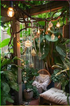 an outdoor area with plants and lights hanging from the ceiling, including a wicker chair