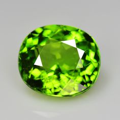 an oval shaped green diamond on a white surface