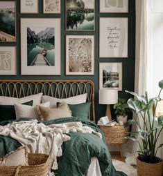 a bedroom with green walls and pictures on the wall above the bed, along with wicker baskets