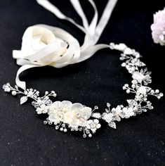 Add a touch of classic elegance to your bridal gown with this beautiful floral belt! Adorned with silk flowers embellished with glowing crystals and pearls on a silver base, it will give your dress an extra touch of glam to finish off your perfect look on your wedding day. The floral appliqué measures approx. 12.5" long (approx. 31.7cm) by 2" wide (approx. 5cm). It can be ordered as appliqué only, attached to your choice of white or ivory double-faced satin ribbon, or white or ivory organza ribb Belt For Wedding Dress, Sequin Belt, Jeweled Belts, Flower Belt, Bridal Sash Belt, Wedding Dress Belt, Crystal Belt, Wedding Sash Belt, Wedding Dresses With Flowers