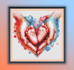 two hands holding a baby's feet in the shape of a heart with watercolor splashes