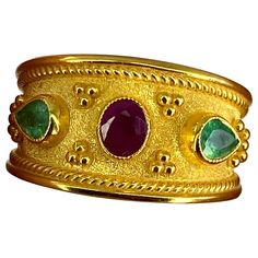 Presenting S.Georgios designer 18 Karat Solid Yellow Gold Ring all handmade in Byzantine Style workmanship with a unique velvet background and granulation. This ring features 0.56 Carat oval cut Ruby in the center and 2 pear shape Emeralds total weight of 0.42 Carat on the sides. This gorgeous piece can also be ordered in all White, or Rose Gold, please get in touch with us. The ring is outstanding in workmanship and stone collection quality and is made in our family workshop in Athens Greece. S Byzantine Gold, Velvet Background, Byzantine Rings, Stone Collection, Athens Greece, Yellow Gold Ring, Emerald Ring, Solid Yellow, Pear Shape