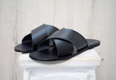 Black Open Toe Slippers With Leather Sole, Black Mules With Leather Sole For Vacation, Black Leather Slides For Beach, Black Leather Slides For The Beach, Black Leather Slide Slippers, Black Leather Beach Slides, Black Open Toe Slippers With Leather Footbed, Black Leather Sole Slide Slippers, Black Slides With Leather Sole For Vacation