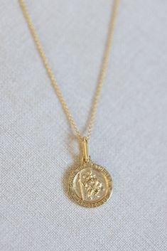 The protection and guidance of Saint Christopher, the patron saint of travelers, in our 14k gold vermeil necklace, beautifully made to accompany you to all of your favorite destinations. Spiritual 14k Gold Coin Necklace, 14k Gold Medallion Necklace In Spiritual Style, Spiritual 14k Gold Filled Yellow Gold Charm Necklaces, Spiritual 14k Gold-filled Yellow Gold Charm Necklace, Spiritual Yellow Gold Plated Medallion Necklace, Spiritual 14k Gold Charm Necklaces With Coin Pendant, Yellow Gold Necklaces With Coin Pendant For Blessing, Spiritual Yellow Gold Coin Necklace, Spiritual Yellow Gold Medallion Charm Necklace