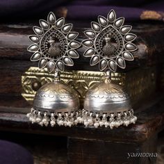 Enhance your look with Mayura jumkis, featuring an elegant oxidized finish complemented by rich 22kt gold plating. These earrings merge classic charm with a contemporary edge, offering a sophisticated accessory that stands out with every wear. Fusion Style Chandbali Brass Jhumkas, Silver Temple Jewelry Chandbalis For Formal Occasion, Dual-tone Earrings For Ceremonial Festive Occasions, Festive Dual-tone Ceremonial Earrings, Ceremonial Dual-tone Festive Earrings, Ceremonial Festive Dual-tone Earrings, Elegant Antique Finish Earrings For Festive Occasions, Ceremonial Chandbali Brass Jhumkas, Traditional Oxidized Finish Earrings For Formal Occasions