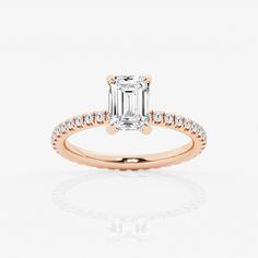 an engagement ring with a baguette cut diamond in the center and side stones on each band