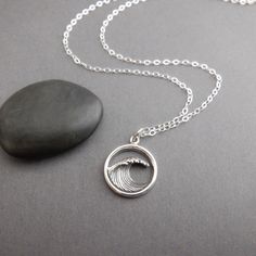 sterling silver ocean wave necklace, 5/8" circle - Sterling silver ocean wave charm, 5/8" (15 mm) across. - Necklace is 1.5 mm cable chain, lobster clasp, and locking circle jump rings, all sterling silver. Length customizable at drop down menu. - Front wave is dimensional/3D. Blackened (oxidized) to bring out details. - Back is flat and shiny, with tiny 925 mark. - Comes wrapped in a cute silver tin, perfect for gift giving or storage, and includes a silver polish pad and care instructions. Cus Cheap Ocean-inspired Silver Necklaces, Wavy Sterling Silver Beach Jewelry, Everyday Silver Jewelry With Wavy Design, Everyday Silver Jewelry With Wavy Shape, Everyday Silver Wavy Jewelry, Surfer Girl Gifts, Bling Things, Wave Jewelry, Wave Necklace