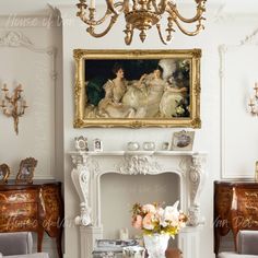 a living room filled with furniture and a painting on the wall