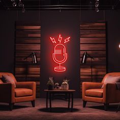 a room with two chairs and a table in front of a neon sign that says radio