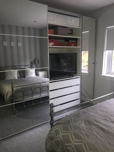 a bedroom with mirrored closet doors and a bed