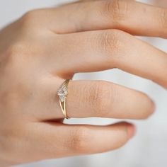 a woman's hand with a diamond ring on it