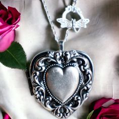 "Heart music box pendant. This heart shaped music box is inspired by the gorgeous music box pendants of era's gone by.  A heart shaped locket has been adorned with a silver ox stamping of a lacey edged floral heart with a solid heart center. The lacey edged floral heart has been covered in a clear resin to give a glass like finish and preserve the beauty of this musical pendant.  The locket opens and closes by pushing the little button on the side and reveals a tiny working music box that plays an 18 note musical tune.  Choose the music box tune you would like at checkout.To listen to the music box tunes, get more information on our music boxes and see our limited addition tune list, go to http://bit.ly/1VJ9Amj The inside front cover of the locket has a lacey floral finish.  You can leave Vintage Heart Locket Necklace For Mother's Day, Vintage Heart Necklace For Mother's Day, Vintage Engraved Heart Necklace For Mother's Day, Vintage Style Engraved Heart Necklace For Mother's Day, Vintage Locket Necklace With Heart Charm For Gifting, Vintage Heart Charm Locket Necklace As A Gift, Vintage Heart Necklace For Valentine's Day Keepsake, Vintage Silver Locket Necklace For Mother's Day, Vintage Heart Locket Necklace Nickel Free