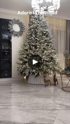 a christmas tree in the middle of a living room with white marble floors and walls