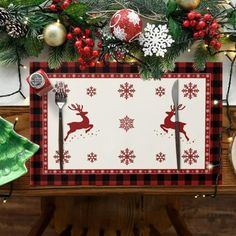 a place mat with reindeers and snowflakes on it, surrounded by christmas decorations