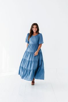 Features Sweetheart neck Flutter sleeves Tiered skirt with floral embroidered detail Smocked back Elastic waist Dusty blue color Pockets Self: 100% Cotton; Lining: 100% Polyester Size + Fit Small 0-4, Medium 4-8, Large 8-12, XL 14-18 Kristin is 5'4", a size 1 and is wearing a Small Runs true to size. Measurements taken while laying flat and then doubled. They do no account for stretch. Click here for shoes Size Bra Band Length Small 34" 49" Medium 36" 49" Large 38" 50" X-Large 40" 50" Dusty Blue Color, Curvy Swim, Curvy Dress, Resort Collection, Tier Skirt, Sweetheart Neck, Tiered Skirt, Flutter Sleeves, Embroidered Dress