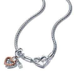 When hearts collide. From Pandora, this romantic set includes a sterling silver studded chain necklace with a flexible, textured chain and an infinity-detailed openable heart clasp that can be styled with up to 4-6 charms or dangle charms. Style it with your favorite charms and any size of Pandora O Pendants. It comes with a heart-shaped double dangle charm features an open heart silhouette in 14k rose gold plating, outlining a sterling silver pave heart. It is decorated with a tiny padlock, ins Elegant Sterling Silver Necklace With Dangling Charms, Elegant Sterling Silver Charm Necklaces With Removable Charms, Elegant Jewelry With Heart Charm On Snake Chain, Elegant Dangle Charms For Valentine's Day, Elegant Sterling Silver Charms With Removable Features, Elegant Sterling Silver Charms With Removable Details, Elegant Valentine's Day Dangle Charms, Silver Heart Necklace With Removable Charms, Silver Jewelry With Removable Heart Pendant Charms