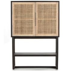 a wooden and rattan cabinet with two doors on the front, one door open