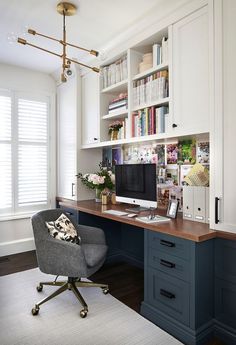 a home office with built - in bookshelves, desk and chair is shown