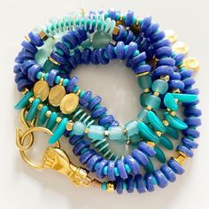 Do you love to explore and go on adventures in the summer? Then you need a versatile and stylish accessory to accompany you every step of the way. Buenaventura necklace/bracelet made with handmade African glass beads in shades of blue/violet and aqua is just what you need. You can wear it as a one or two-loop necklace or as a multi-loop bracelet. Additionally, its fist-shaped closure serves as a lucky charm.  Add a touch of color and originality to your summer look with this must-have accessory! Blue Natural Stones Bracelets For Beach, Blue Natural Stone Bracelets For Beach, Blue Natural Stone Beach Bracelets, Adjustable Blue Multi-strand Jewelry, Adjustable Multi-strand Blue Jewelry, Blue Gemstone Beads Jewelry For Beach, Blue Hand-strung Necklaces For Beach, Hand-strung Blue Necklaces For The Beach, Blue Hand-strung Necklace For Beach