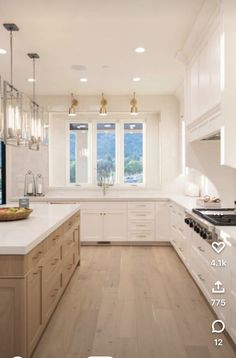 a kitchen filled with lots of white counter top next to a wooden flooring area