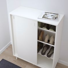 there is a shoe cabinet with shoes in it