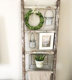 an old ladder is used as a shelf to display plants and other things on the wall