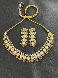 KUNDAN WEDDING BRIDAL NECKLACE CHOKER SET  Material :  HIGH quality GOLD plated brass, JADE, PEARL stones  Finish :  GOLD plated  Featuring :  LENGTH              ADJUSTABLE      Specility : 1. top RATED shop                    2. FREE delivery                    3. FAST delivery service                    4. lower PRICE from others                    5. HIGH quality products                    6. all jewelry items are made by HAND with                          LOVE and CARE                    7 Yellow Jewelry For Anniversary And Festivals, Kundan Necklaces For Marriage, Handmade Gold Kundan Necklace For Wedding, Gold Beads Jewelry For Wedding And Festivals, Yellow Round Necklace For Celebration, White Temple Jewelry Beaded Necklaces For Wedding, White Temple Jewelry Beaded Necklace For Wedding, White Festive Necklace For Marriage, Festive White Necklaces For Anniversary