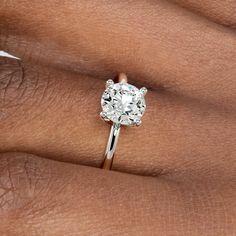 a woman's hand with a diamond ring on it