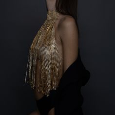 Turn heads and make a statement with our stunning Gold Crystal Chain Halter Top. This exquisite piece of evening wear is designed to dazzle and impress, perfect for special occasions, glamorous nights out, or any event where you want to shine. Premium Quality: Crafted from high-quality materials, this halter top features intricately linked gold chains adorned with sparkling crystals. Unique Design: The backless design with delicate chain details adds a touch of elegance and sophistication, ensur Glamorous Gold Body Chain For Evening, Gold Body Chain For Parties, Elegant Gold Body Chain For Party, Glamorous Gold Body Jewelry For Evening, Glamorous Gold Body Chain For Night Out, Gold Embellished Evening Necklaces, Glamorous Gold Body Jewelry For Night Out, Gold Embellished Evening Necklace, Glamorous Chain Body Jewelry For Parties