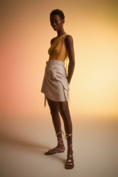 Light beige, asymmetrical cargo skirt with two functional pockets. Hidden snap closure at the front. Model is wearing sample size 34.Materials: 97% COTTON, 3% EAModel Measurements:Height: 180 cmChest: 83 cmWaist: 65 cmHip: 89 cmWears 34Runs true to size take your usual size.Care Instructions: Dry Clean Only Chic Asymmetrical Wrap Skirt With Pockets, Beige Asymmetrical Bottoms For Work, Asymmetrical Beige Bottoms For Work, Chic Bottoms With Belt Loops And Asymmetrical Hem, Chic Asymmetrical Skirt With Pockets, Utility Cargo Skirt For Summer Workwear, Chic Summer Cargo Skirt With Belt Loops, Chic Mini Skirt With Cargo Pockets, Summer Workwear Khaki Cargo Skirt