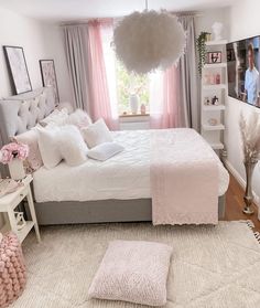 a bedroom with pink and white decor in it