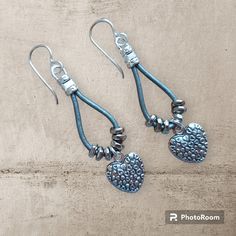 Antique Pewter Hearts on Heart Charm Earrings dangle from metallic grey leather.  Silver tone hypoallergenic earwires complete the look. To keep beads leather and all other components looking their best, avoid contact with water, lotions and perfumes. To access all other items in my shop, just hit the link here: https://www.etsy.com/ca/shop/KootenayLeatherRHS Antique Silver Earrings, Dangle Earrings Silver, Earrings Antique, Earrings Bohemian, Antique Pewter, Bohemian Earrings, Earrings Drop, Antique Earrings, Bead Leather