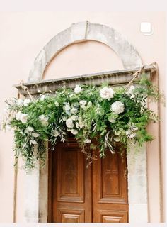 the doors are decorated with greenery and flowers