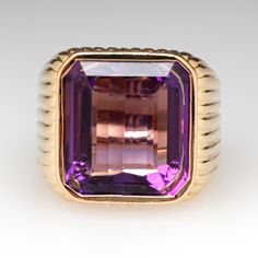 This amazing ring features a fluted design and is accented with one (1) emerald cut natural amethyst set into a bezel setting. The ring measures 16.1mm at the top, rises 7.6mm above the finger, tapering to 6.3mm wide and 1.3mm thick at the base of the shank. It is currently a size 4.75. Emerald Cut Amethyst Ring For Formal Occasions, Luxury Amethyst Ring Emerald Cut, Luxury Emerald Cut Amethyst Ring, Luxury Purple Amethyst Ring, Rectangular Shape, Luxury Purple Amethyst Rectangular Ring, Luxury Purple Rectangular Amethyst Ring, Luxury Formal Jewelry With Fluted Bezel, Luxury Emerald-cut Amethyst Ring For Formal Events, Luxury Emerald Cut Amethyst Ring For Formal Occasions